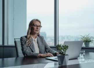 Sharply dressed real estate investor using her laptop to explore business opportunities